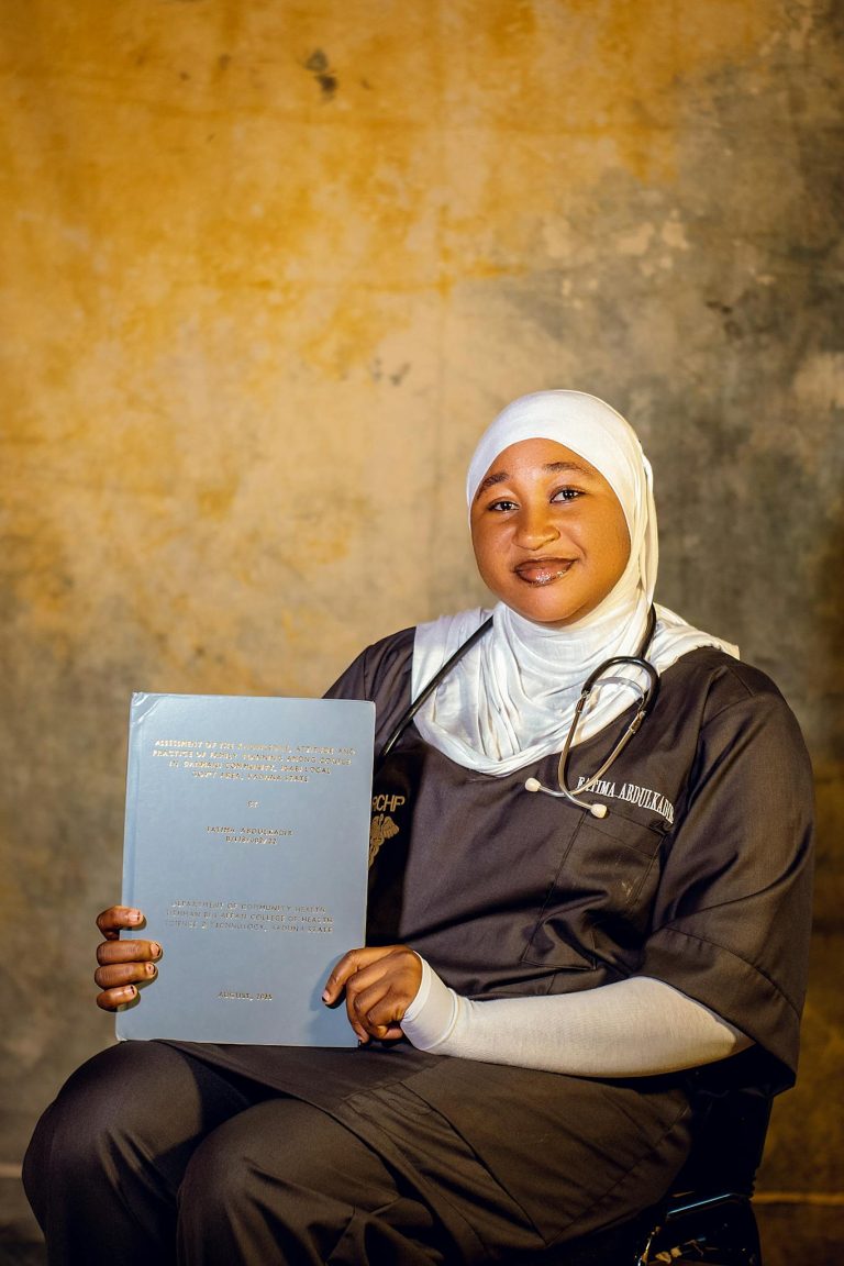 Smiling healthcare worker with certificate, symbolizing achievement and dedication.